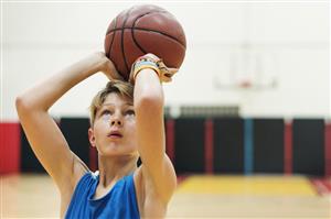 Boy shooting basketball